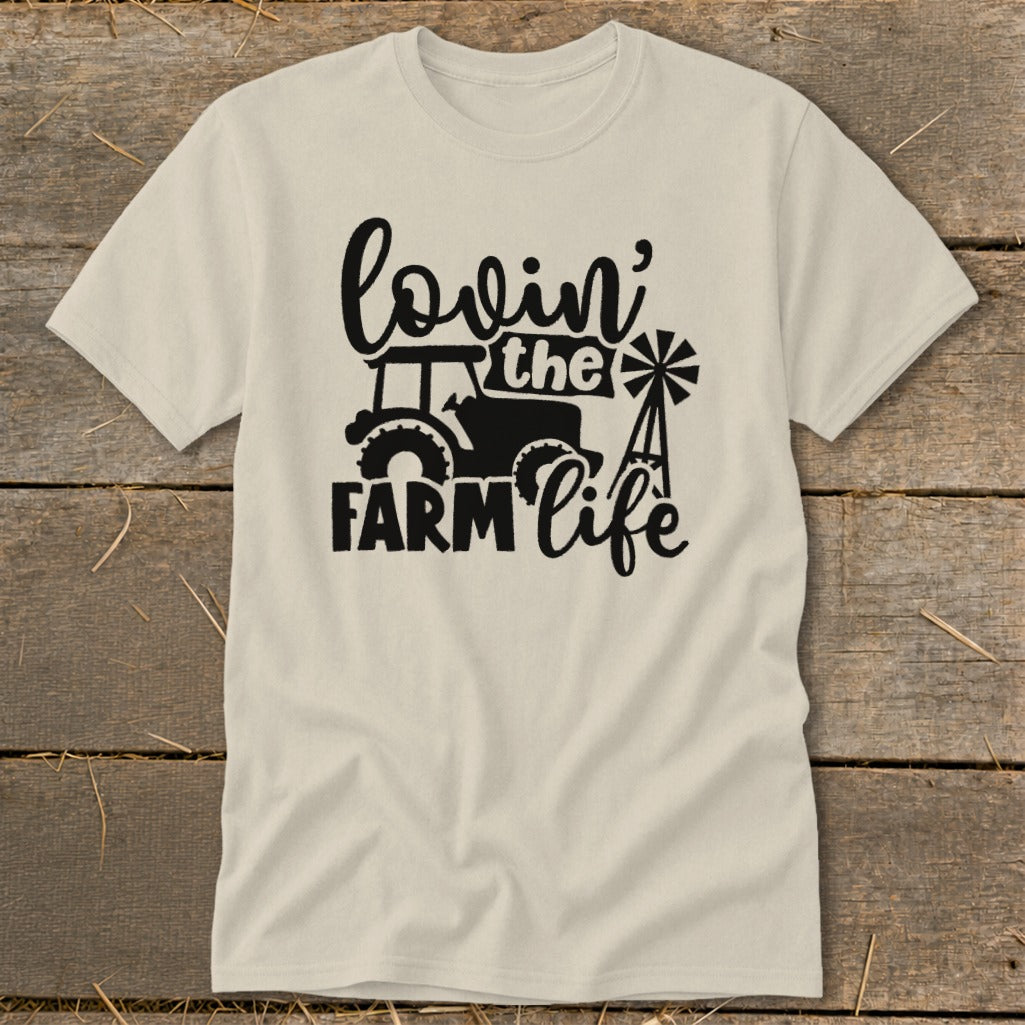 Cream t-shirt with black graphic: tractor, windmill, and text "lovin' the FARM life".