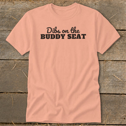 Peach t-shirt with black text that reads "Dibs on the BUDDY SEAT".