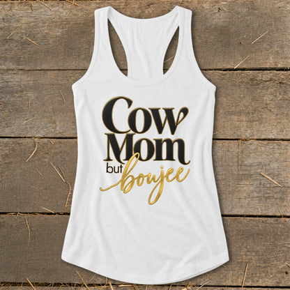 White tank top with "Cow Mom but boujee" text in black and gold.