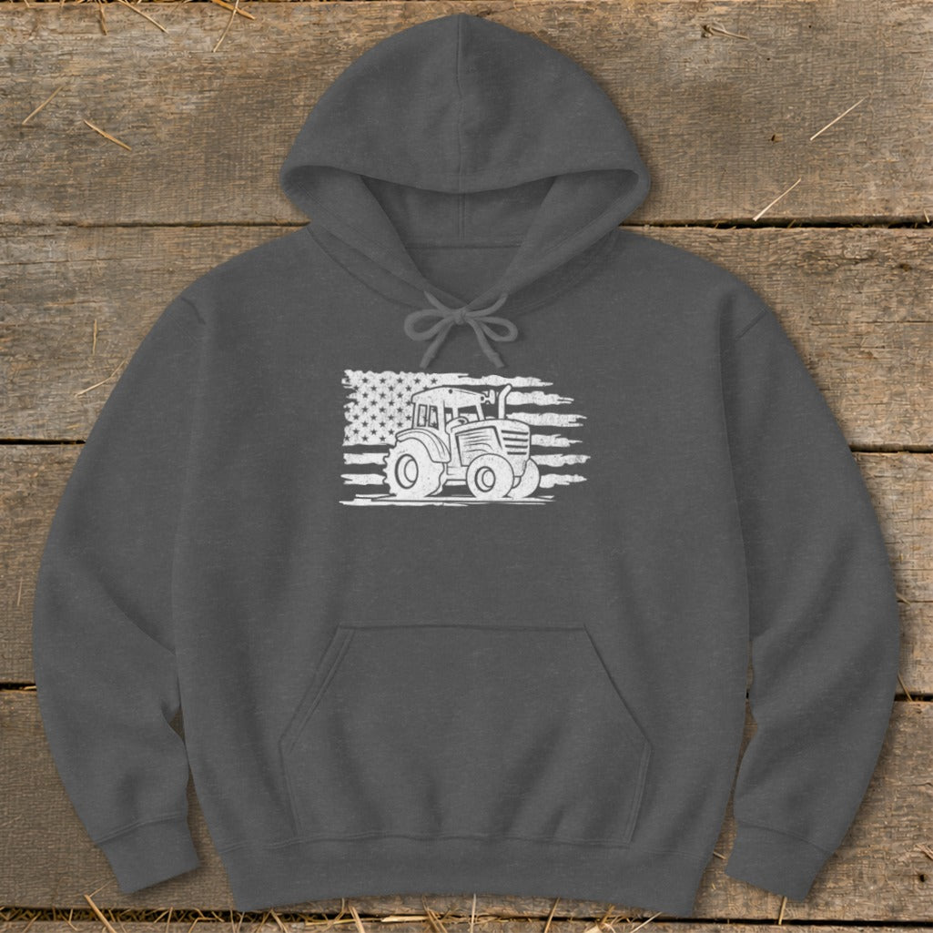 Dark gray hoodie with a white tractor graphic against a distressed American flag.