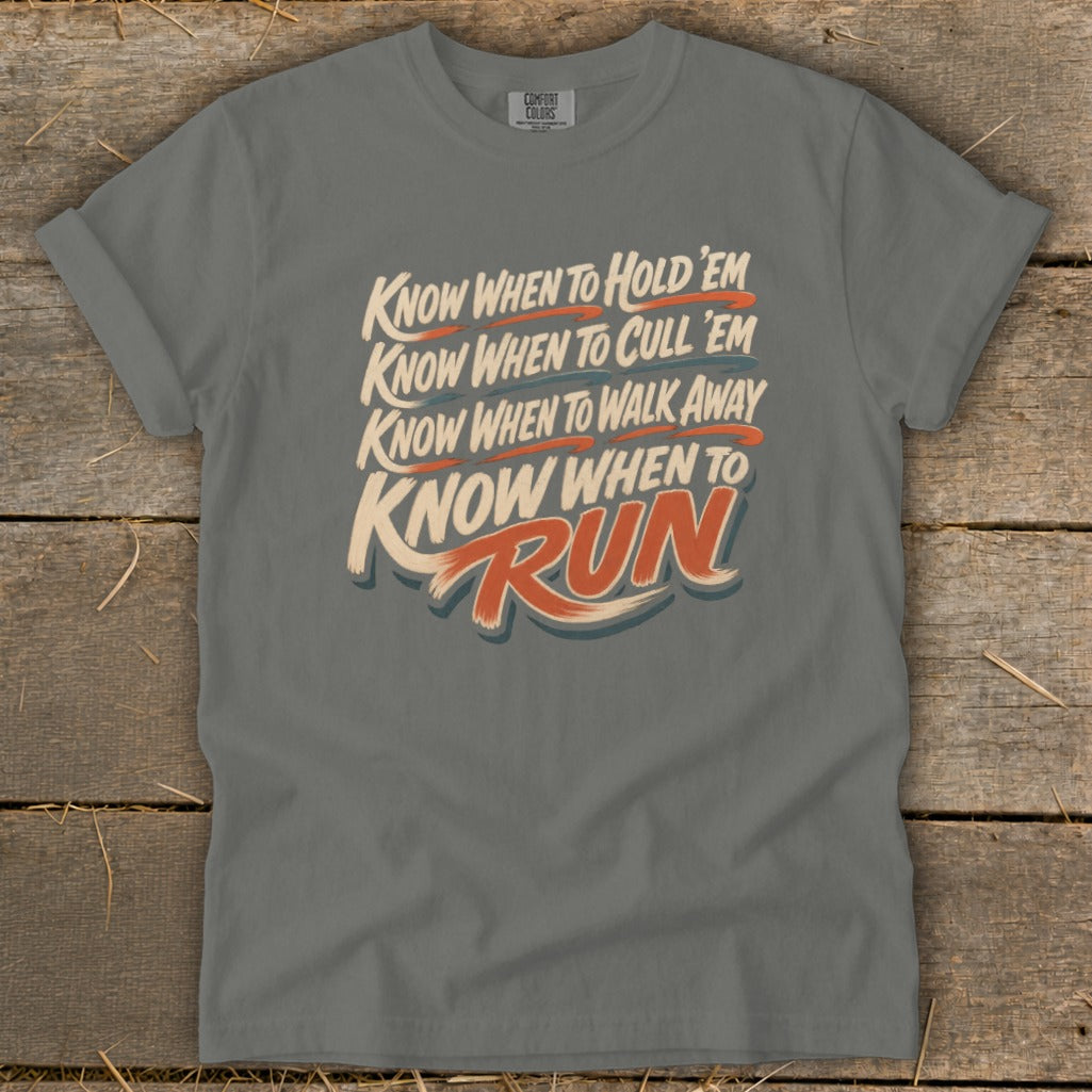 T-shirt with "Know when to hold 'em, cull 'em, walk away, run" text.