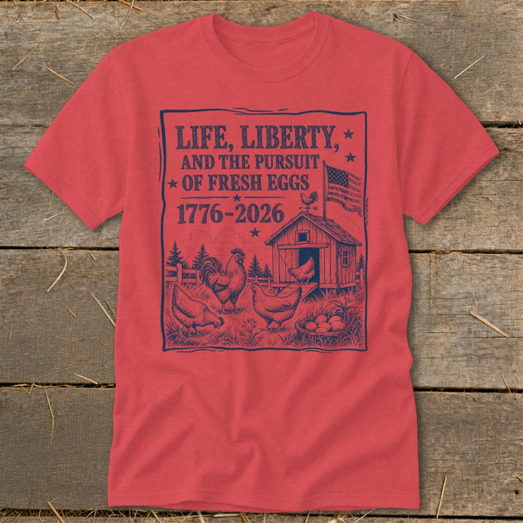 Red t-shirt with graphic: "Life, Liberty, and the Pursuit of Fresh Eggs 1776-2026" with chickens.