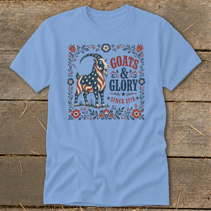 Light blue t-shirt with a patriotic goat and "GOATS & GLORY SINCE 1776" text.