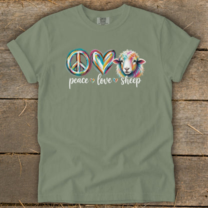 Olive green t-shirt with peace, heart, and colorful sheep graphic and text.