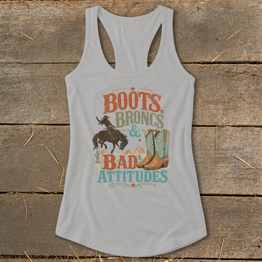 Light gray tank top with "Boots, Broncs & Bad Attitudes" graphic featuring cowboy, horse, boots, and desert scene.