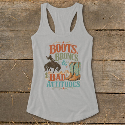 Light gray tank top with "Boots, Broncs & Bad Attitudes" graphic featuring cowboy, horse, boots, and desert scene.