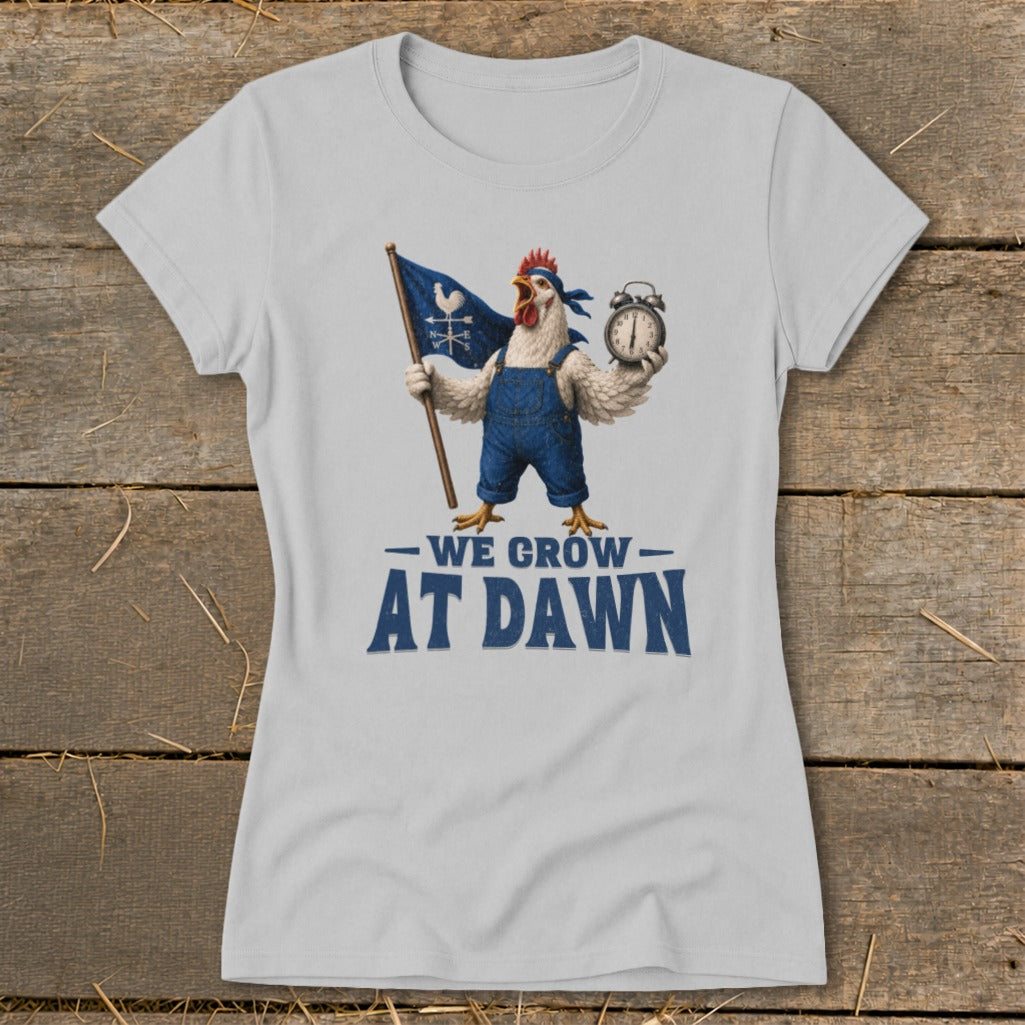 T-shirt graphic of chicken holding flag and alarm clock, reads "We Grow At Dawn".