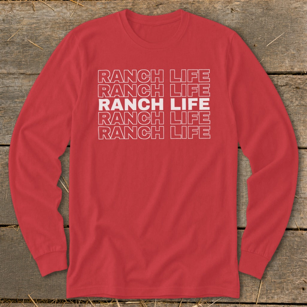 Red long-sleeve crewneck shirt with layered white outlined text reading RANCH LIFE on a wooden background.