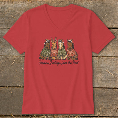 Four horses wearing Santa hats and sweaters, with text "Seasons Greetings from the Herd".