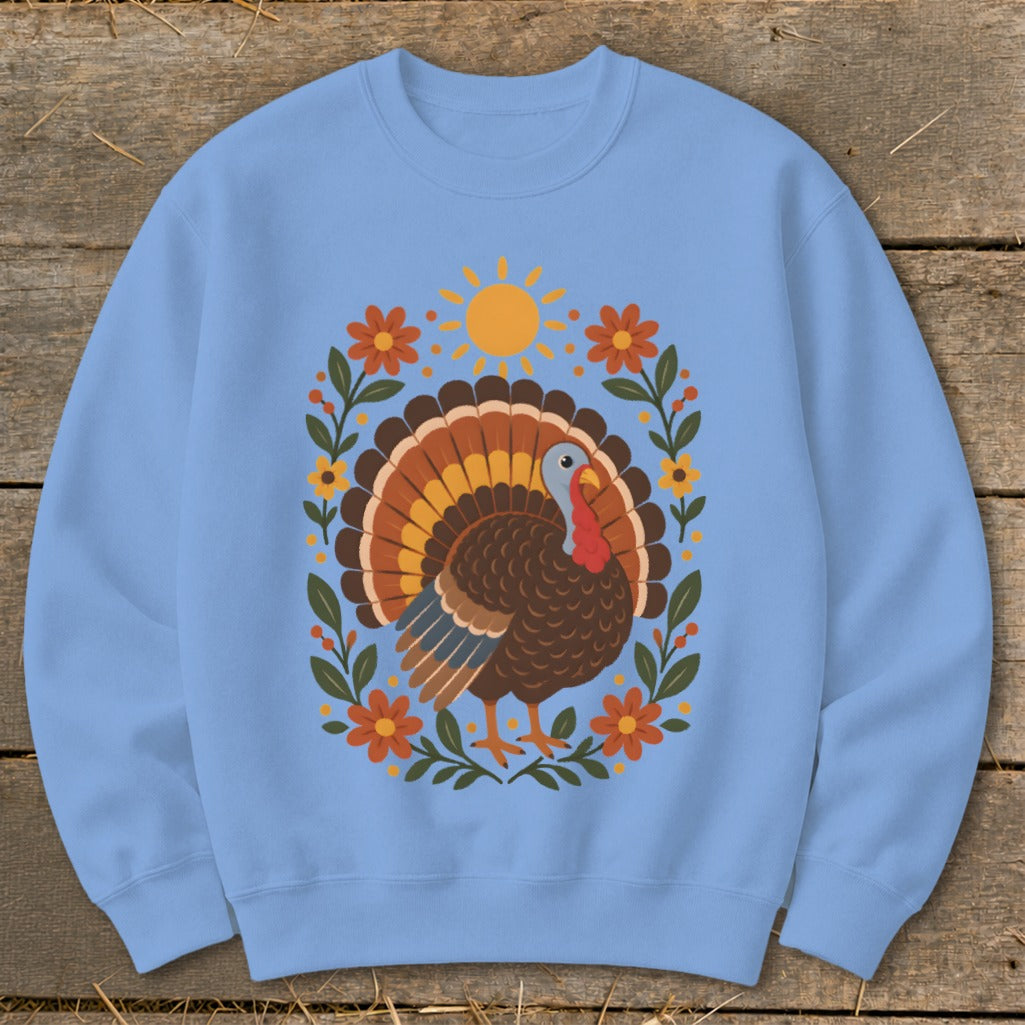 Light blue sweatshirt with a graphic of a turkey surrounded by flowers and a sun.
