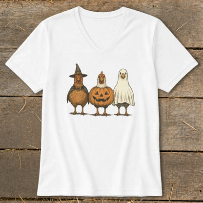 Three chickens dressed in Halloween costumes: witch hat, pumpkin, and ghost.