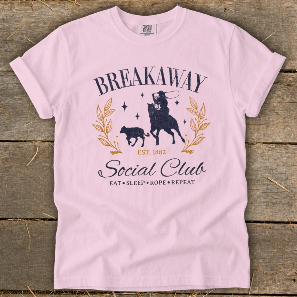 Pink t-shirt with "Breakaway Social Club EST. 1882 Eat Sleep Rope Repeat" graphic.