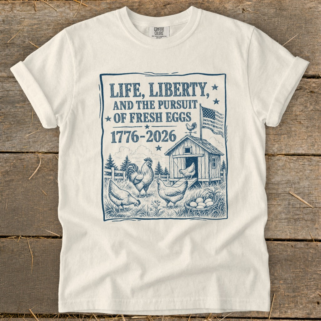 T-shirt with "Life, Liberty, and the Pursuit of Fresh Eggs 1776-2026" design.