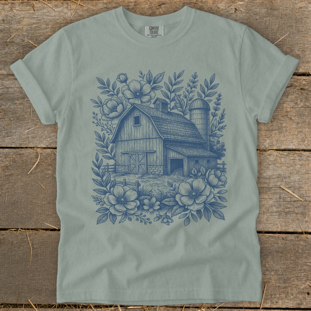 Blue line art t-shirt with barn, silo, flowers, and foliage design.