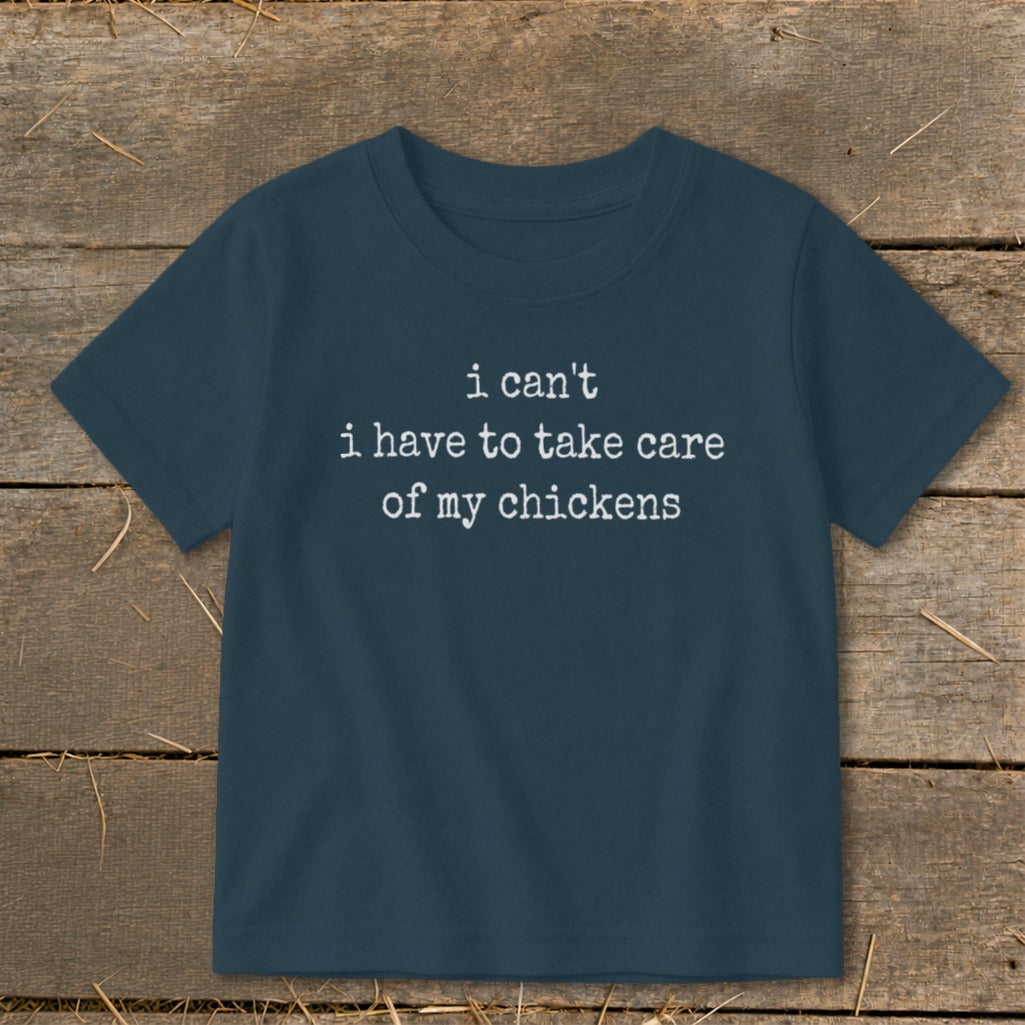 Dark blue t-shirt with white text reading "i can't i have to take care of my chickens".