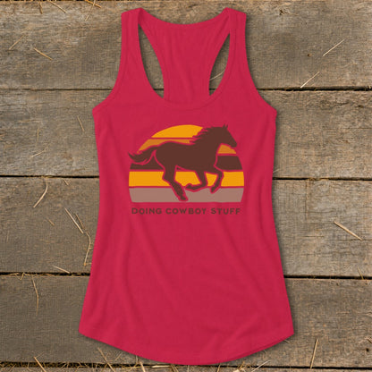 Red tank top with a running horse graphic and "DOING COWBOY STUFF" text.