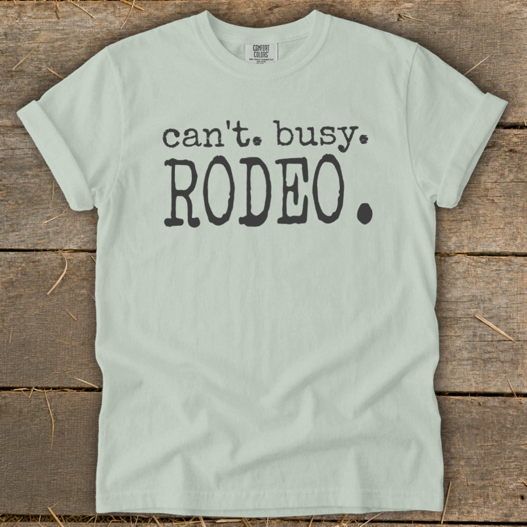Light green t-shirt with black text that reads "can't. busy. RODEO."