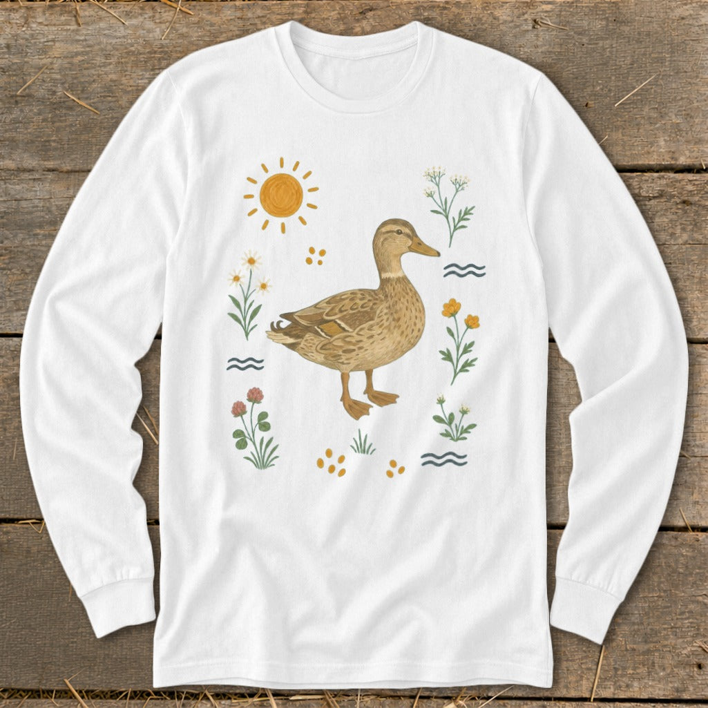 White long sleeve shirt with a mallard duck illustration surrounded by flowers and sun.