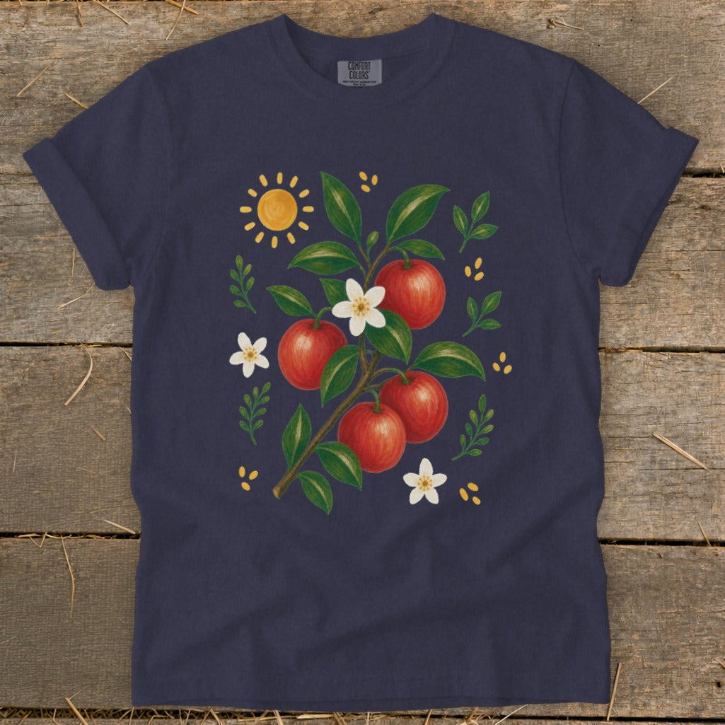 Dark blue t-shirt with a watercolor illustration of a branch with apples, flowers, and sun.