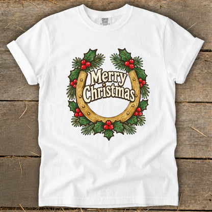 White t-shirt with a horseshoe wreath featuring "Merry Christmas" text and holly berries.