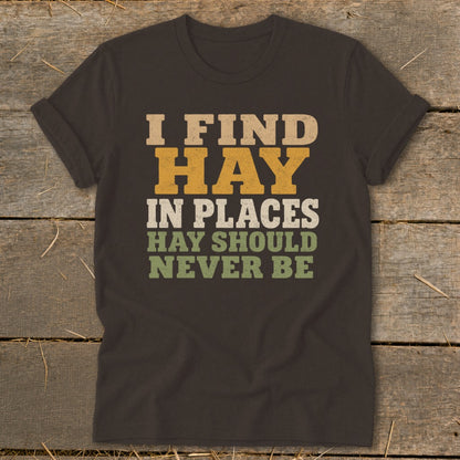 Dark t-shirt with "I FIND HAY IN PLACES HAY SHOULD NEVER BE" text.