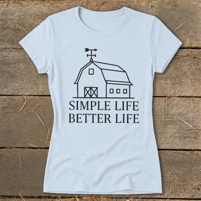 Light blue t-shirt with line art barn graphic and text "SIMPLE LIFE BETTER LIFE".