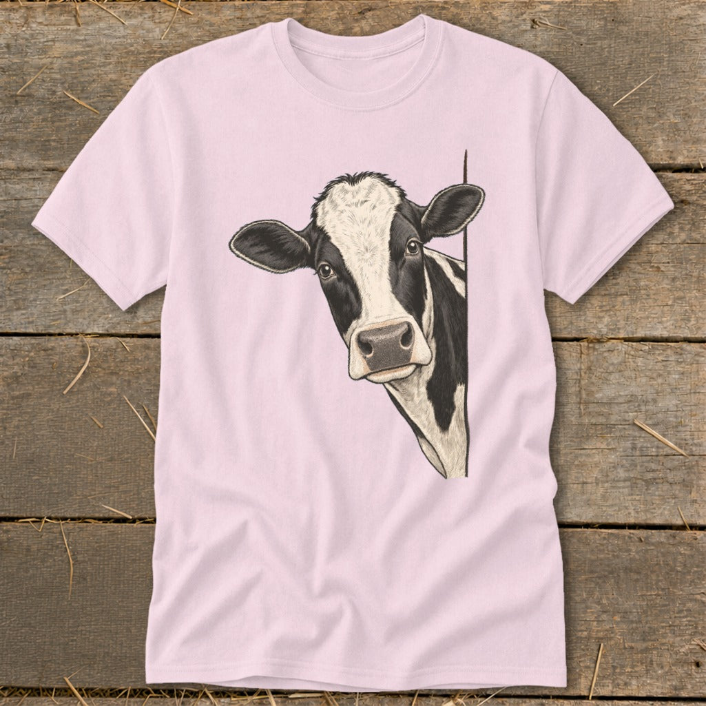 Pink t-shirt with a black and white cow peeking around a corner.