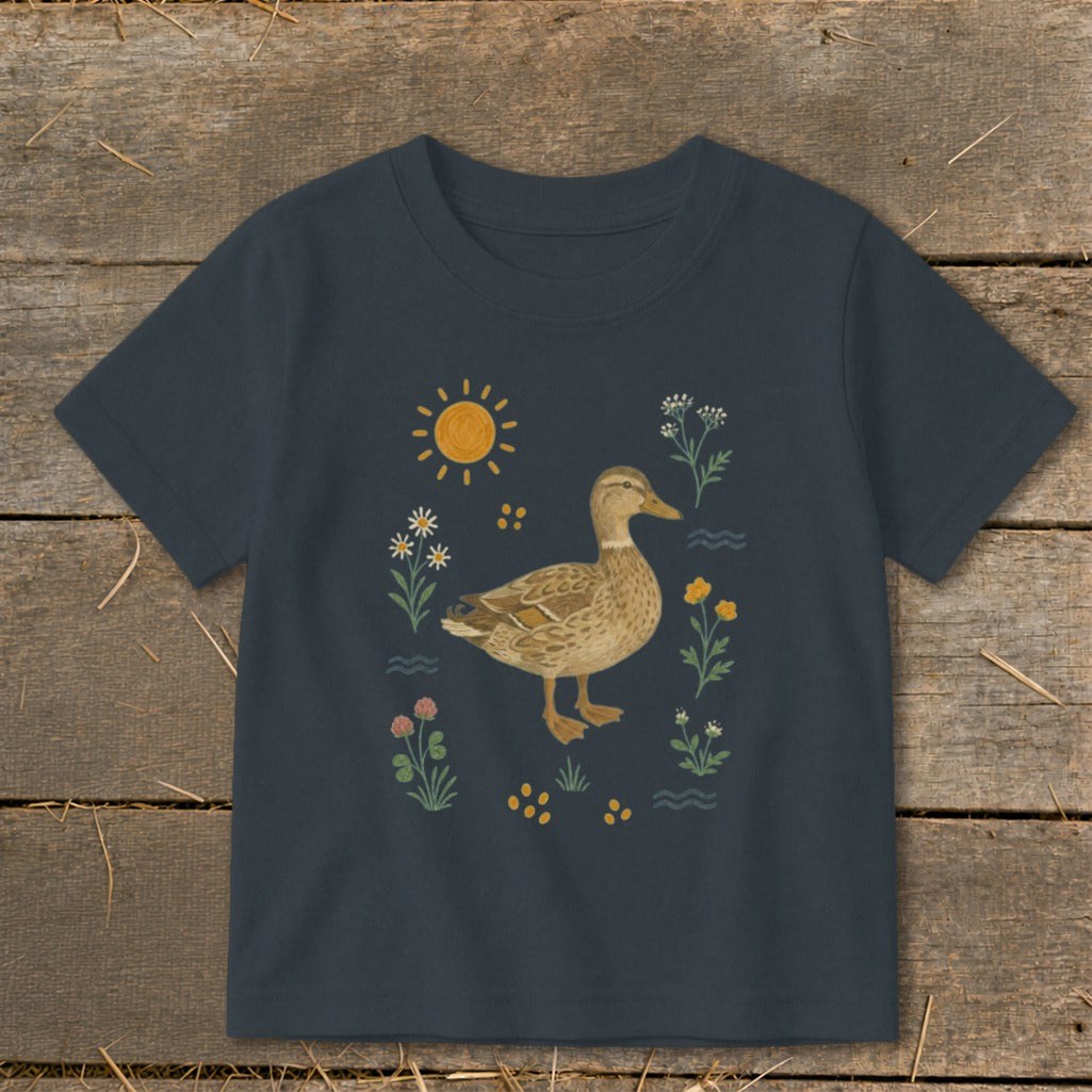 Dark t-shirt with a cartoon duck surrounded by flowers and sun graphic.