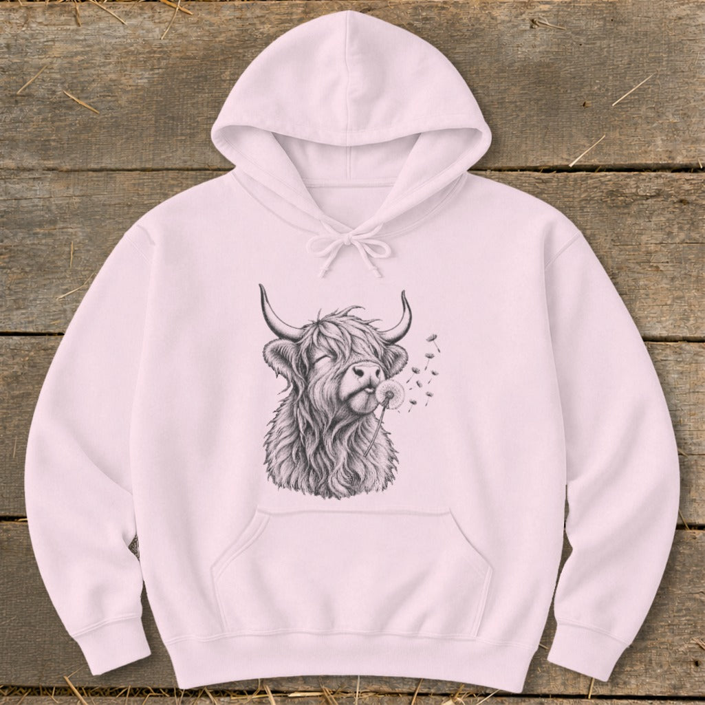 Pink hoodie with sketch of Highland cow blowing dandelion seeds.