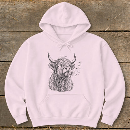 Pink hoodie with sketch of Highland cow blowing dandelion seeds.