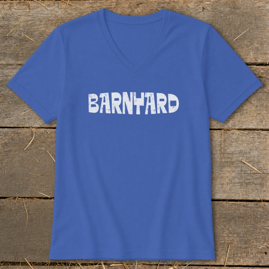 A blue V-neck t-shirt with the word BARNYARD printed in white on the front, displayed on a wooden surface.