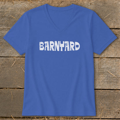 A blue V-neck t-shirt with the word BARNYARD printed in white on the front, displayed on a wooden surface.