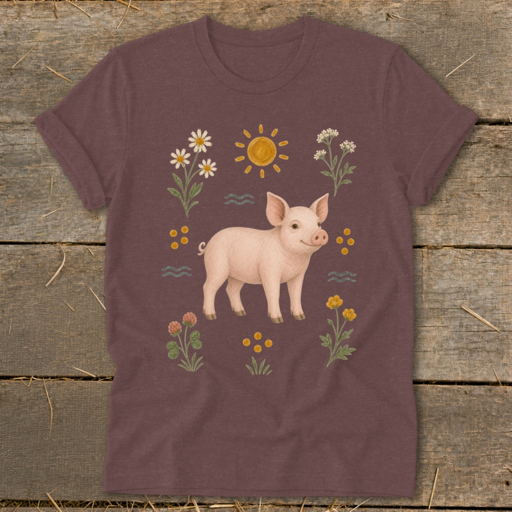 Brown t-shirt with a piglet surrounded by flowers, sun, and waves.