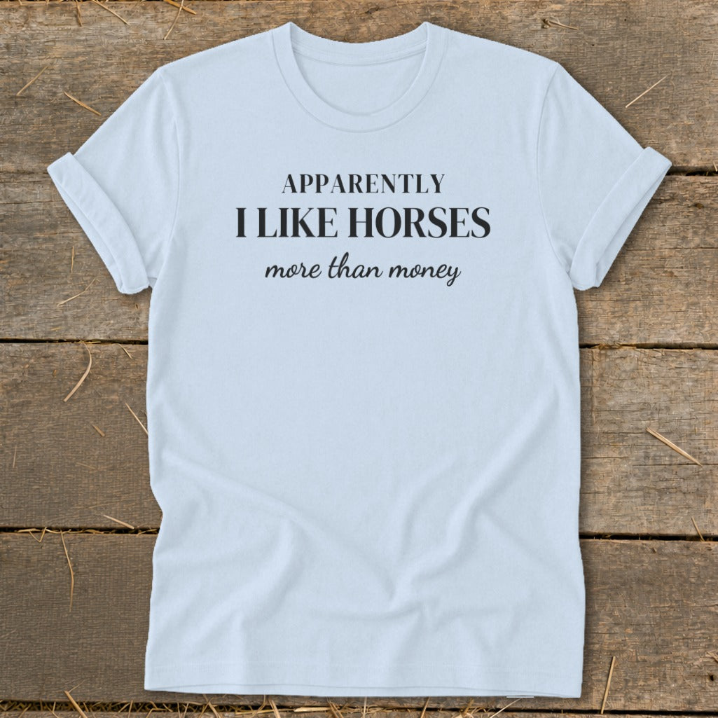 Light blue t-shirt with text "APPARENTLY I LIKE HORSES more than money."