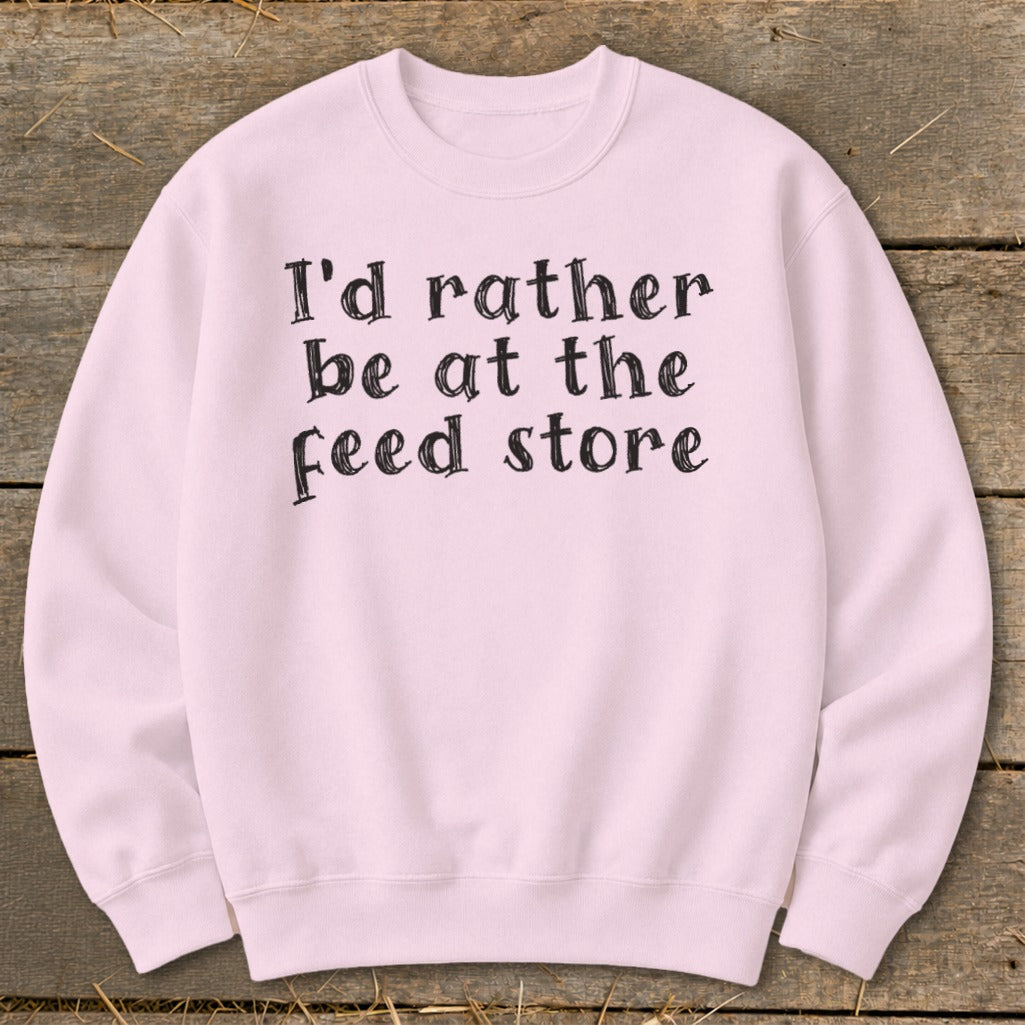 Light pink sweatshirt with black text "I'd rather be at the feed store".