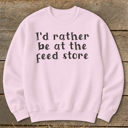 Light pink sweatshirt with black text "I'd rather be at the feed store".
