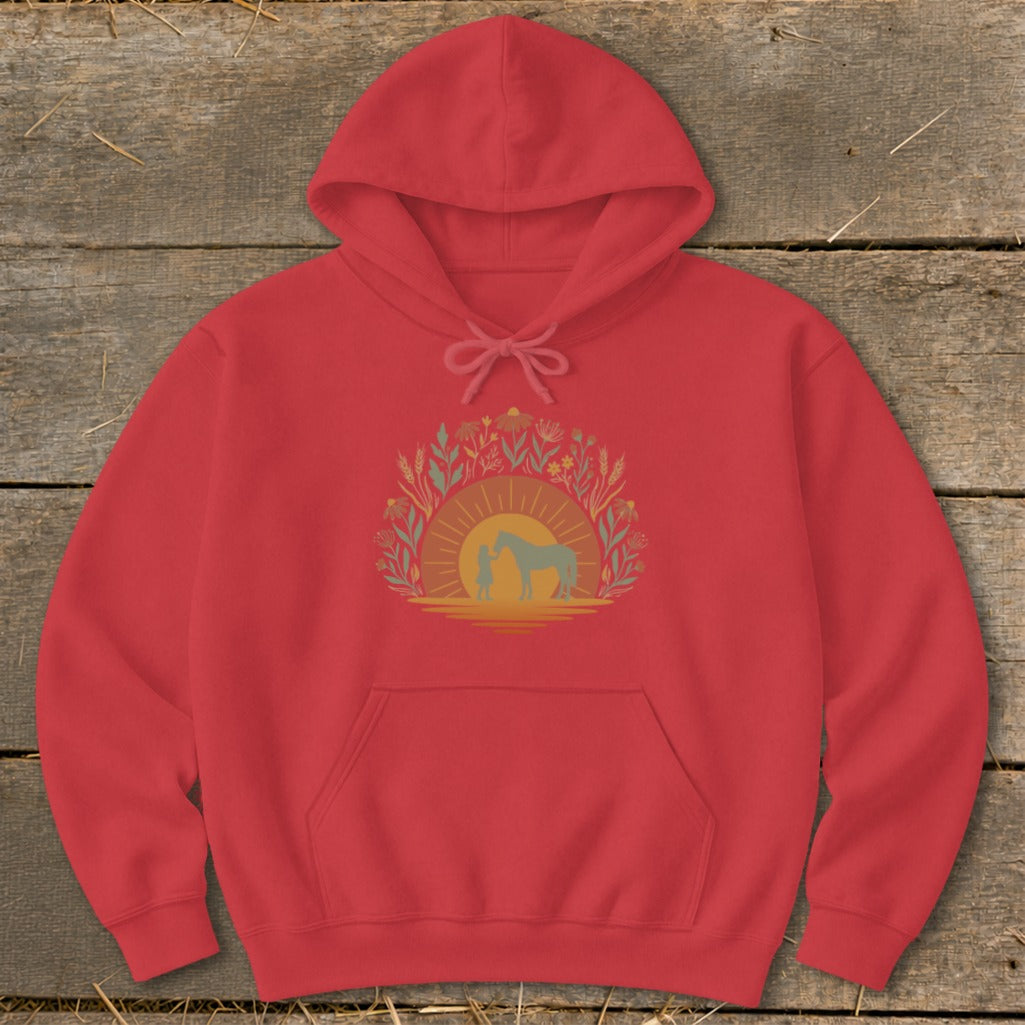 Red hoodie with a graphic of a person and horse at sunset surrounded by foliage.