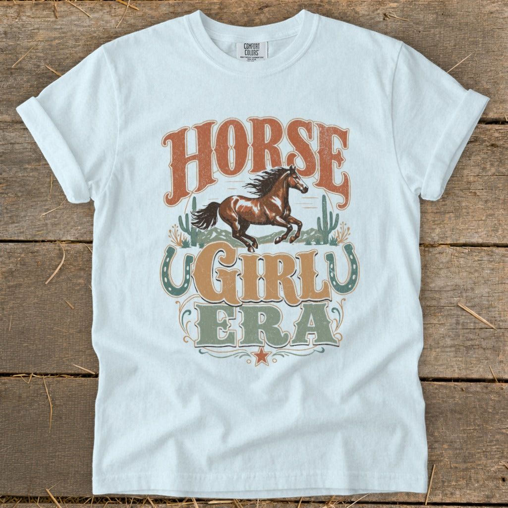 White t-shirt with "HORSE GIRL ERA" text and a running horse graphic.