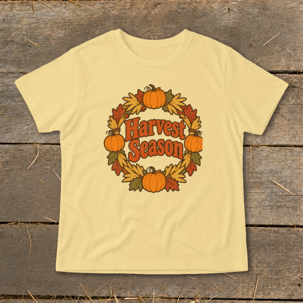 Yellow t-shirt with a circular design featuring pumpkins, leaves, and "Harvest Season" text.