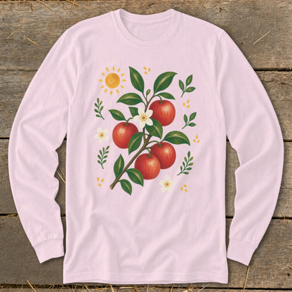 Pink long-sleeve shirt with a painted apple branch and sun graphic.