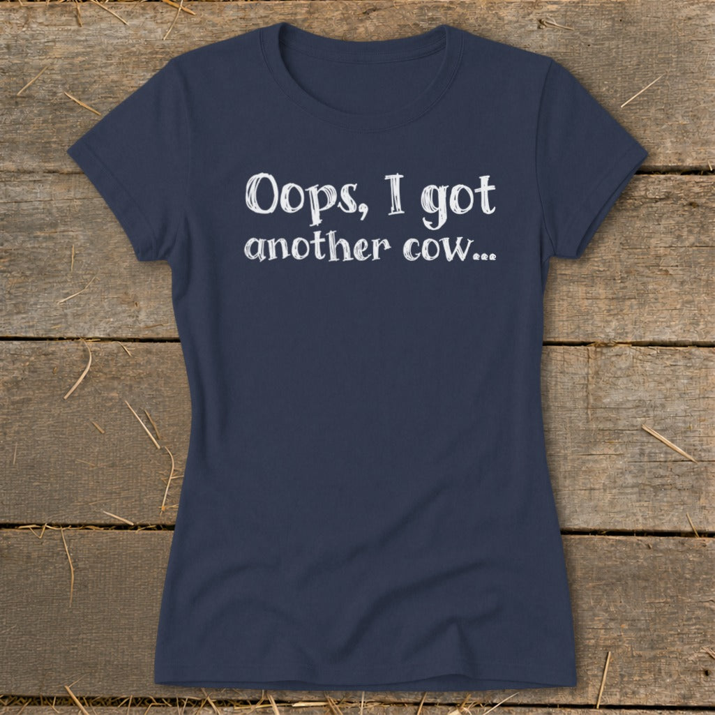 Navy blue t-shirt with white text: "Oops, I got another cow..."