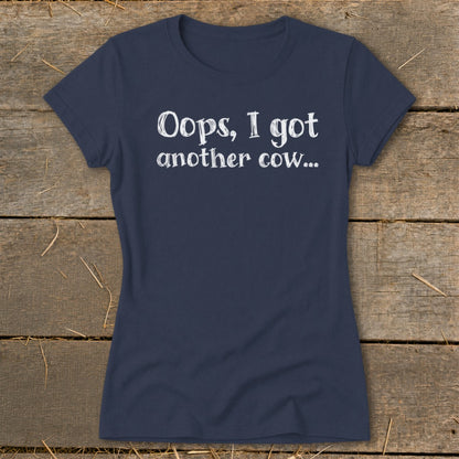 Navy blue t-shirt with white text: "Oops, I got another cow..."