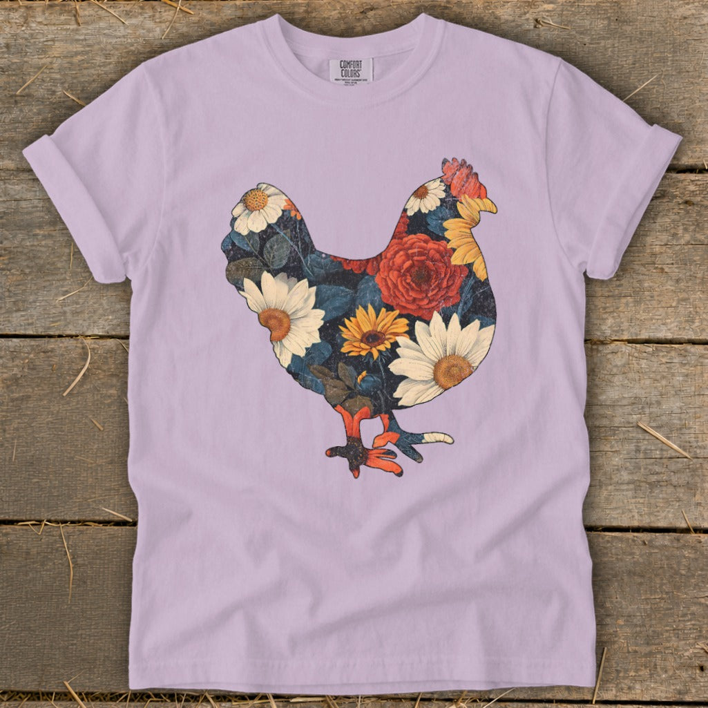 Lilac t-shirt with a chicken silhouette filled with colorful flowers and leaves.