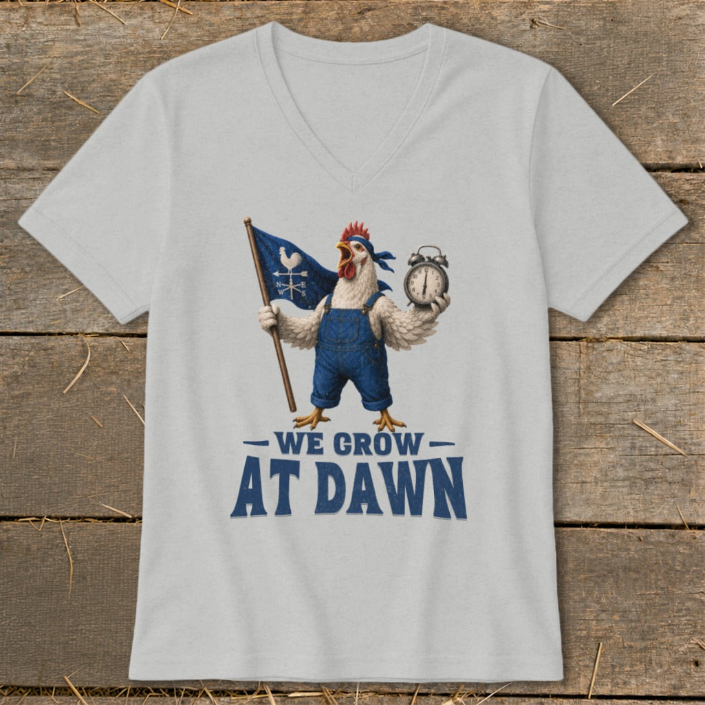 White t-shirt with graphic of rooster holding flag and alarm clock, text reads "WE GROW AT DAWN".