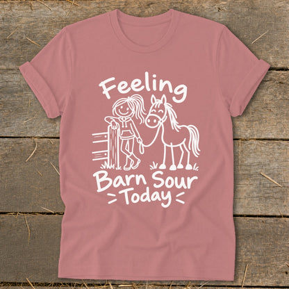 Pink t-shirt with white text "Feeling Barn Sour Today" and horse graphic.