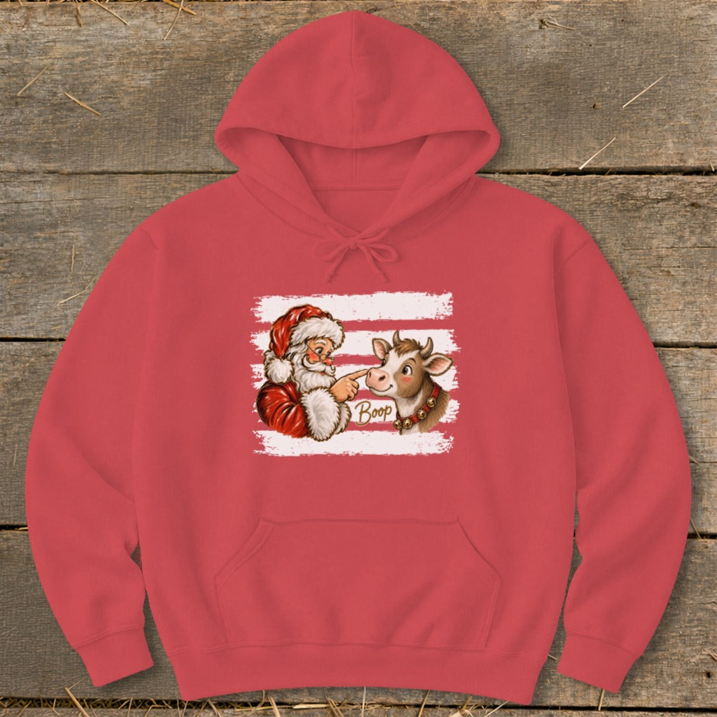 Santa booping a cow's nose with the word "Boop" on a red hoodie.