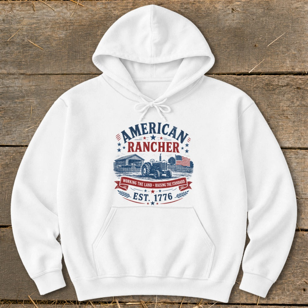 White hoodie with "American Rancher" graphic featuring a tractor and barn.