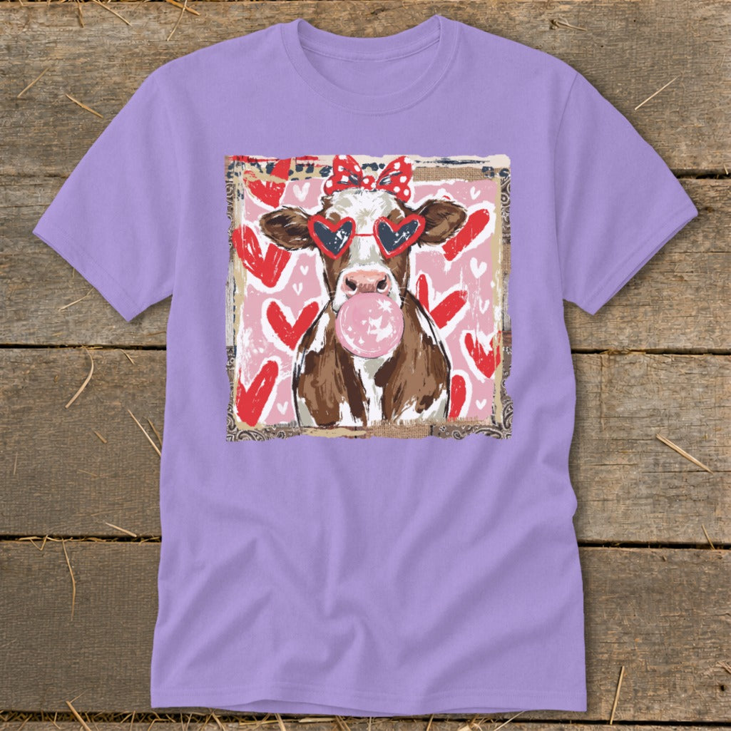 Cow wearing heart sunglasses and red polka dot bow, blowing pink bubble gum.