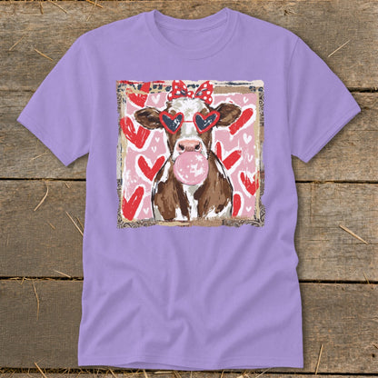 Cow wearing heart sunglasses and red polka dot bow, blowing pink bubble gum.