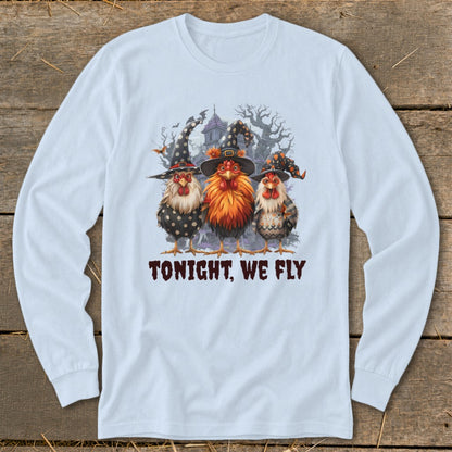 Three chickens wear witch hats in front of a haunted house. Tonight, We Fly text.